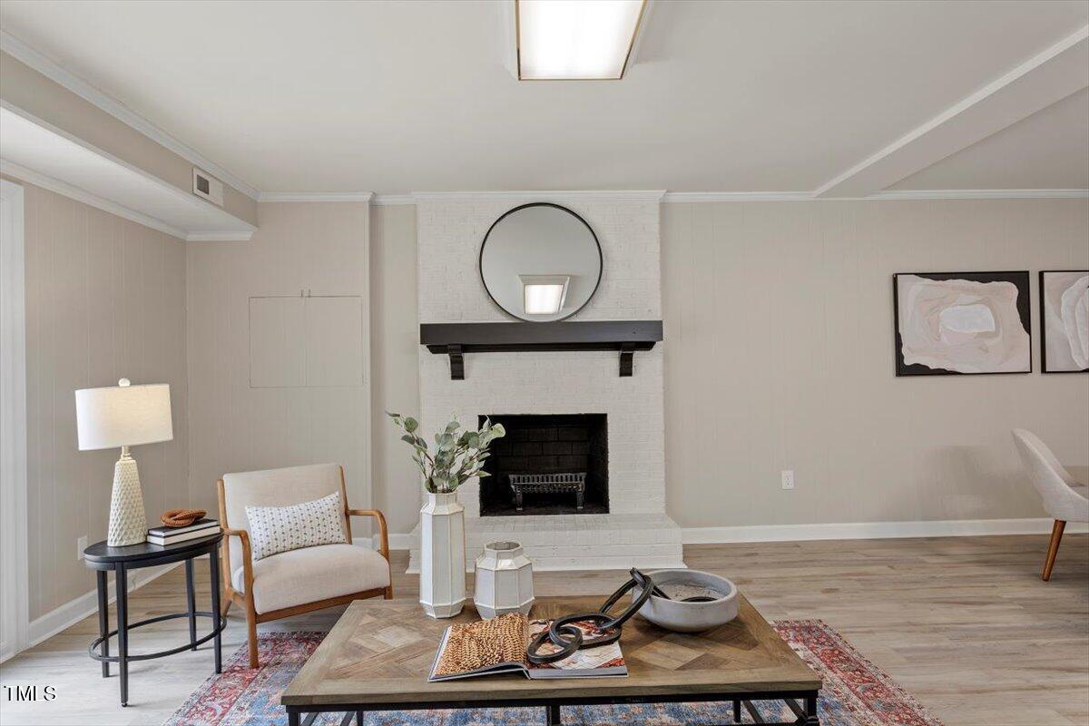 7300 Grist Mill Road Raleigh, NC 27615 - Photo 29 of 41 a living room with furniture a fireplace and a table
