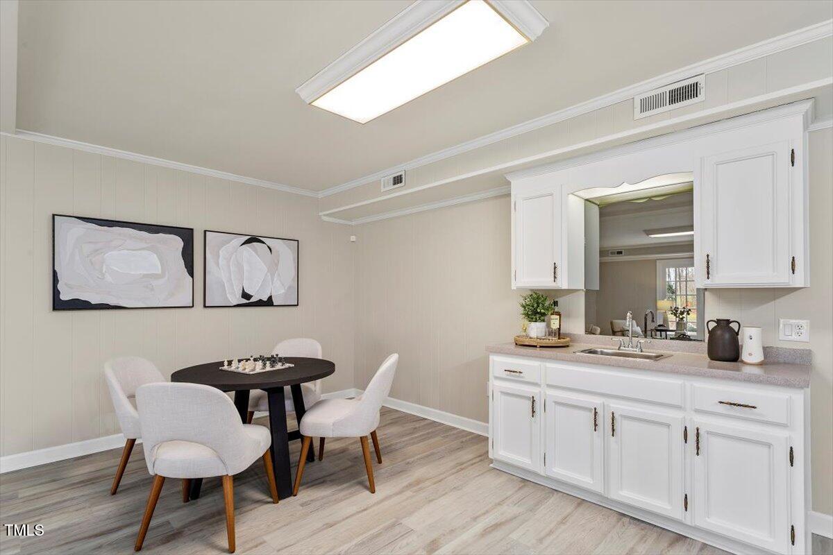 7300 Grist Mill Road Raleigh, NC 27615 - Photo 31 of 41 a dining room with wooden floor and stainless steel appliances