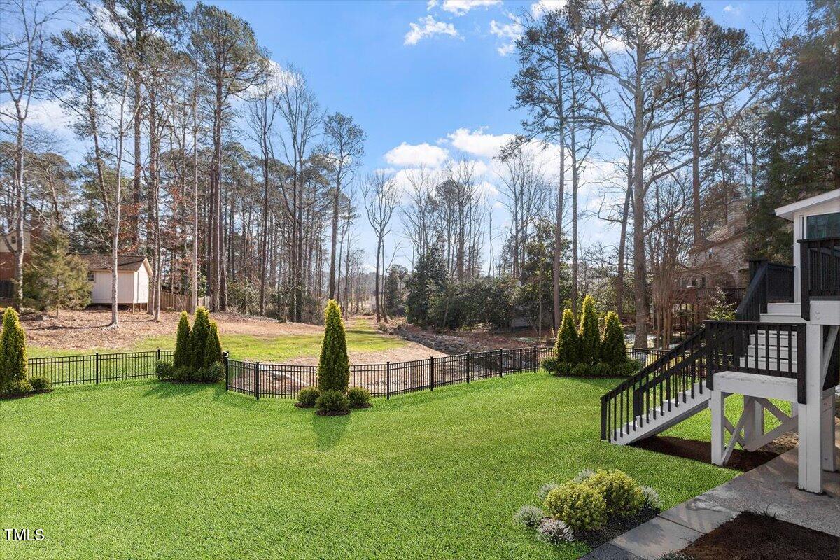 7300 Grist Mill Road Raleigh, NC 27615 - Photo 39 of 41 a front view of a house with garden and sitting area