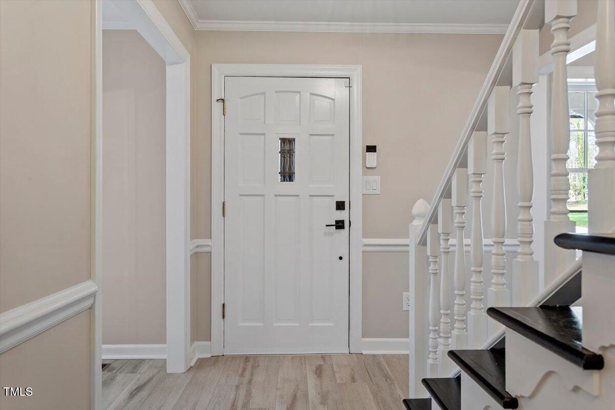 7300 Grist Mill Road Raleigh, NC 27615 - Photo 4 of 41 a view of an entryway with wooden floor