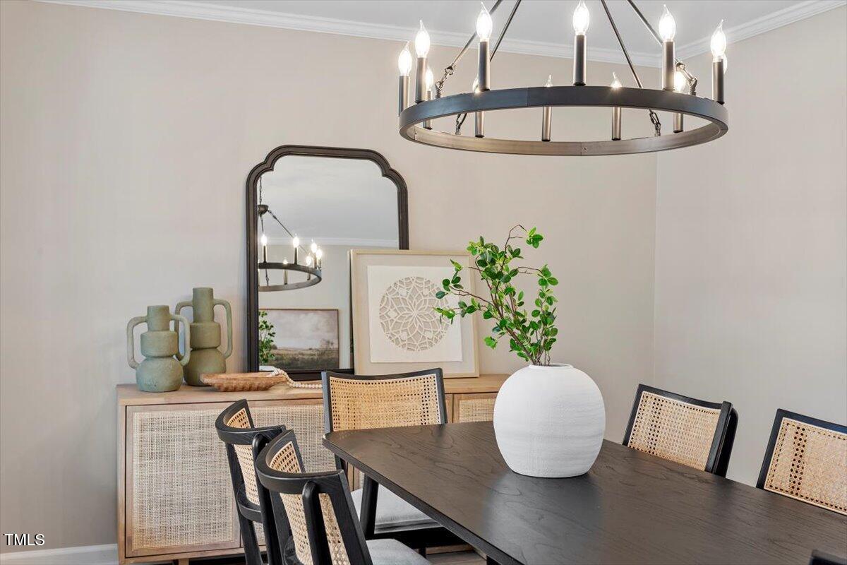 7300 Grist Mill Road Raleigh, NC 27615 - Photo 7 of 41 a view of a dining room with furniture and wooden floor