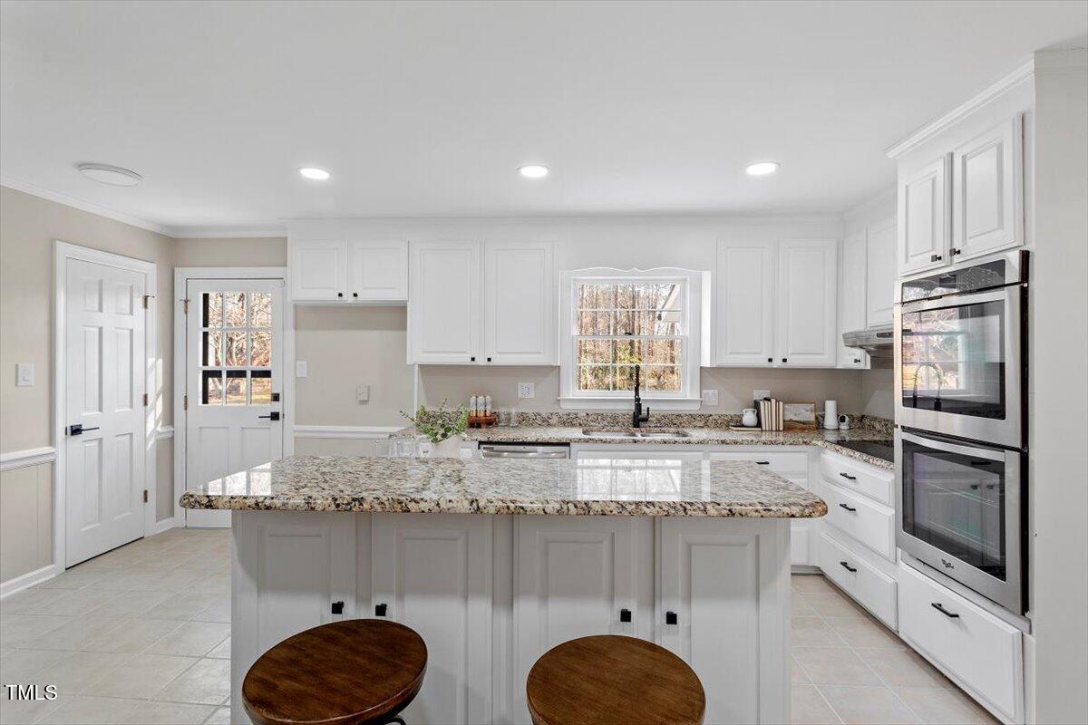 7300 Grist Mill Road Raleigh, NC 27615 - Photo 9 of 41 a kitchen with granite countertop a sink stove and refrigerator