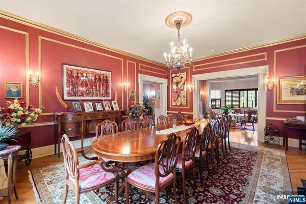 a kitchen with stainless steel appliances granite countertop a stove a sink dishwasher a dining table and chairs with wooden floor