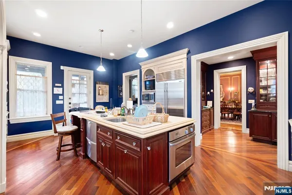 a kitchen with a stove and a wooden floor
