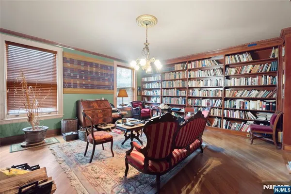 a living room with furniture a fireplace and a chandelier