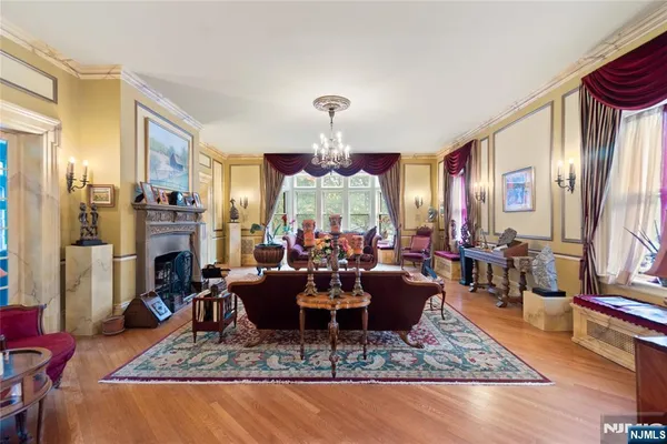 a living room with fireplace furniture and a chandelier