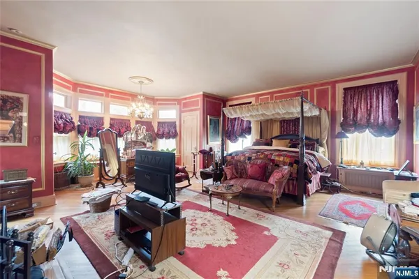 a living room with furniture a flat screen tv and a floor to ceiling window