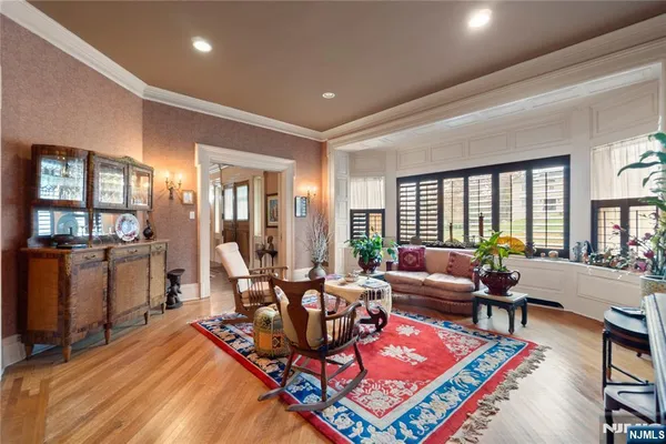 a living room filled with furniture and a potted plant