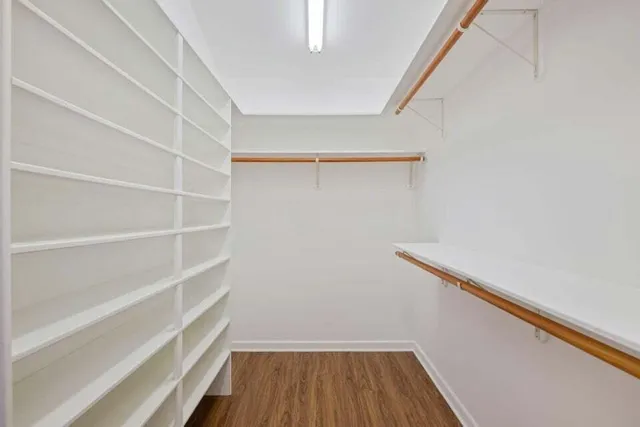 a view of walk in closet with empty racks
