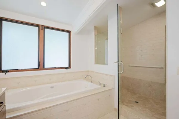 a bathroom with a bathtub and a shower