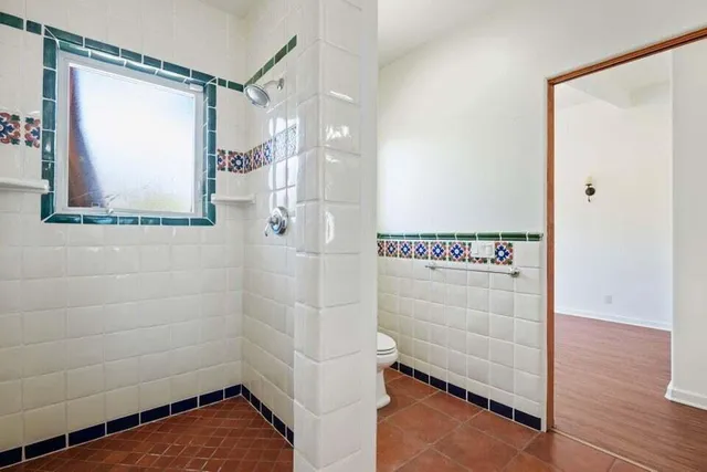 a bathroom with a shower and a window