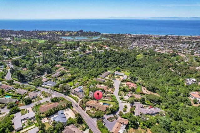 an aerial view of a city and mountain view in back