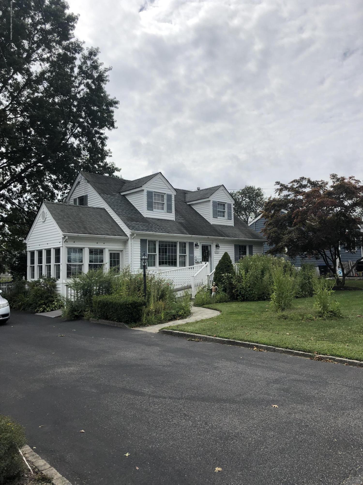 1111 Minnesink Road Manasquan, NJ 08736 - Photo 1 of 9 a front view of a house with a garden