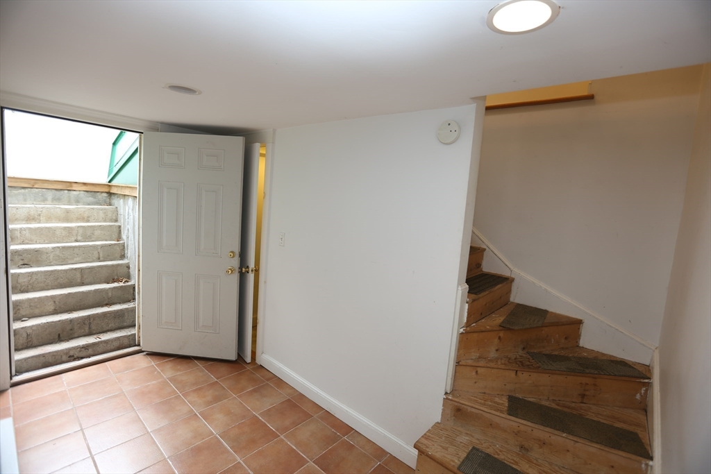 12 Lasell Street Boston, MA 02132 - Photo 12 of 22 a view of entryway with stairs and wooden floor