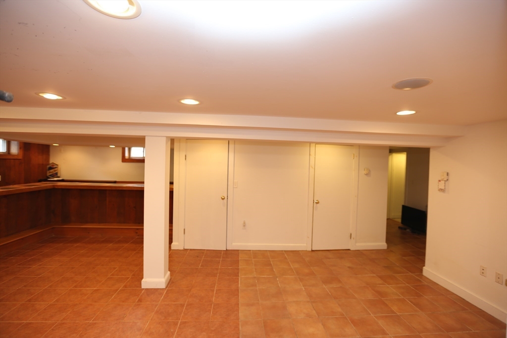 12 Lasell Street Boston, MA 02132 - Photo 14 of 22 an empty room with cabinet and mirrors