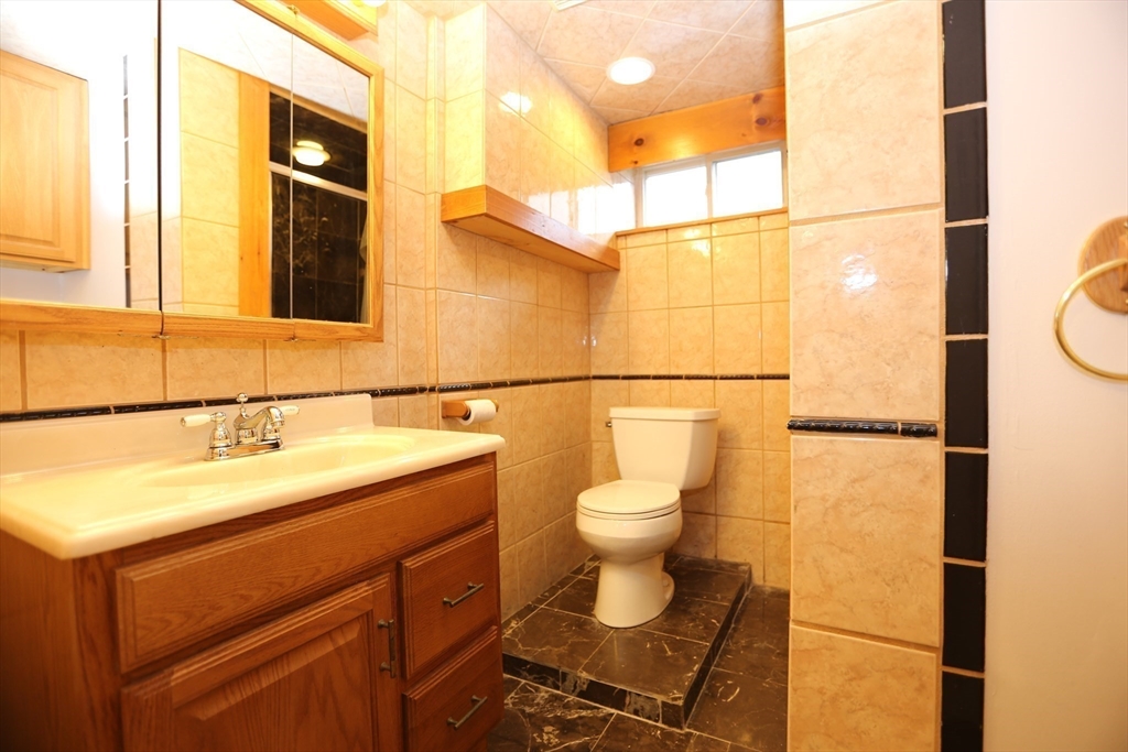 12 Lasell Street Boston, MA 02132 - Photo 15 of 22 a bathroom with a sink a toilet and shower