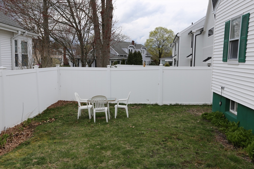12 Lasell Street Boston, MA 02132 - Photo 21 of 22 a backyard of a house with table and chairs