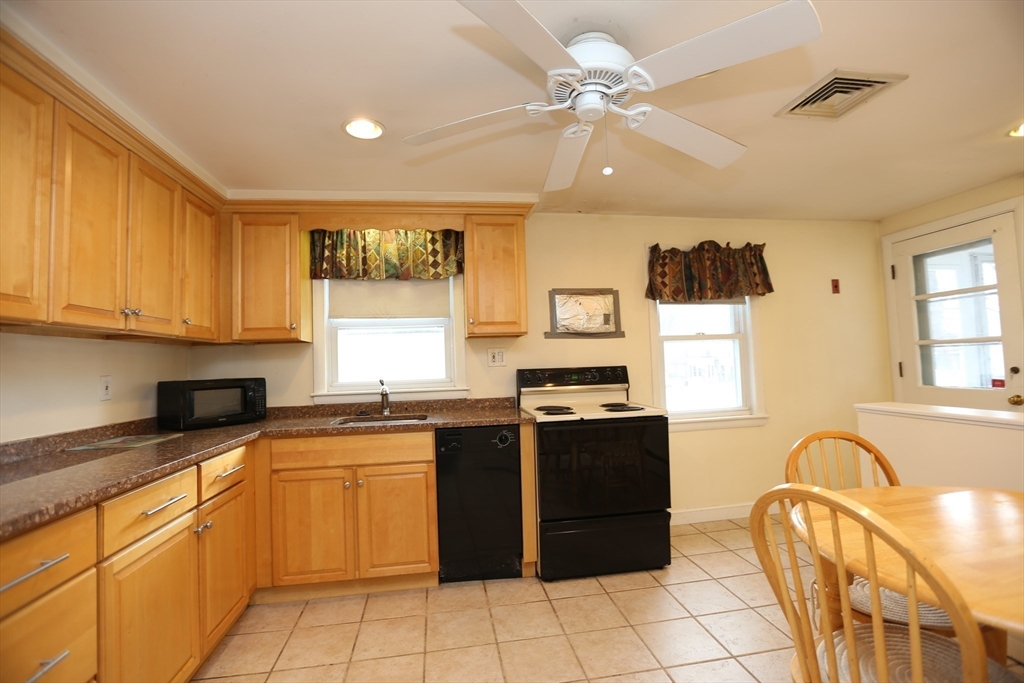 12 Lasell Street Boston, MA 02132 - Photo 4 of 22 a kitchen with stainless steel appliances granite countertop a stove sink and cabinets