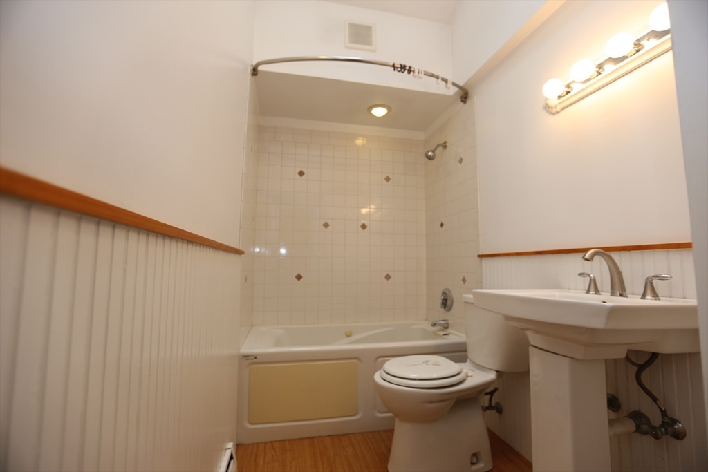 12 Lasell Street Boston, MA 02132 - Photo 8 of 22 a bathroom with a sink toilet and shower