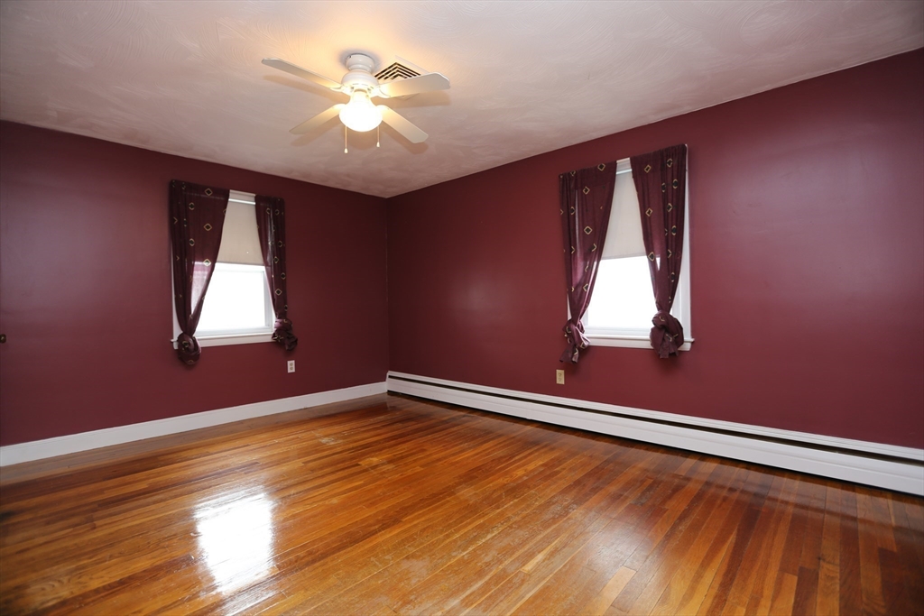 12 Lasell Street Boston, MA 02132 - Photo 9 of 22 wooden floor in an empty room with a window