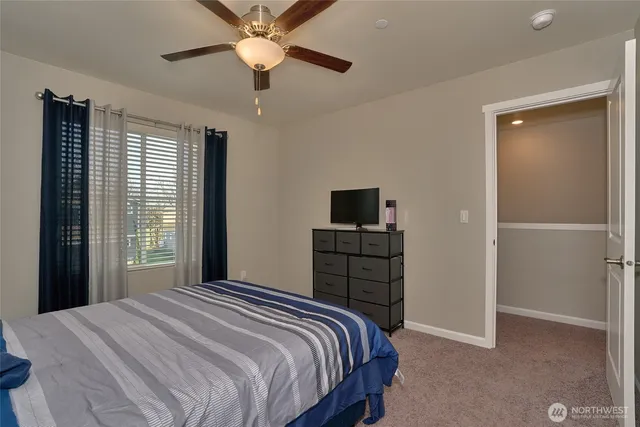 a bedroom with a bed and a tv