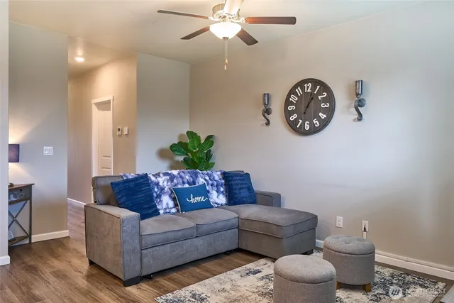 a living room with furniture and a wooden floor