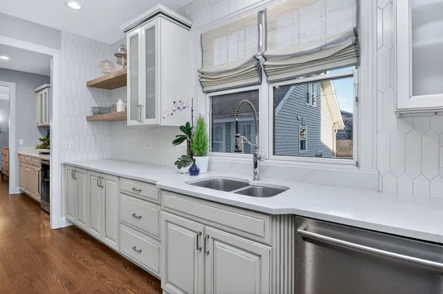 a kitchen with cabinets a sink and appliances
