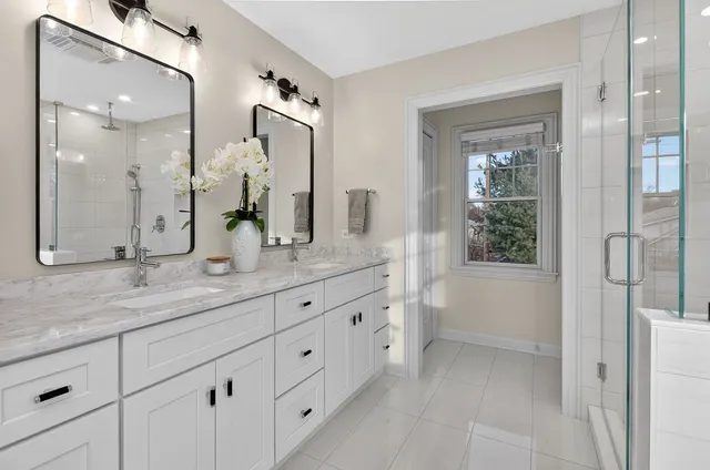 a bathroom with a granite countertop sink mirror and double