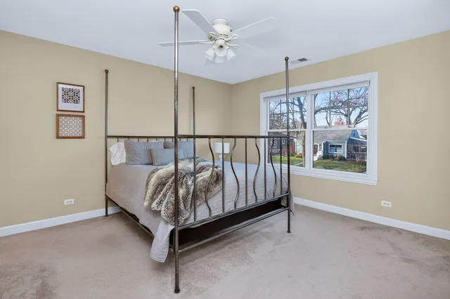 a bed sitting in a room next to a window
