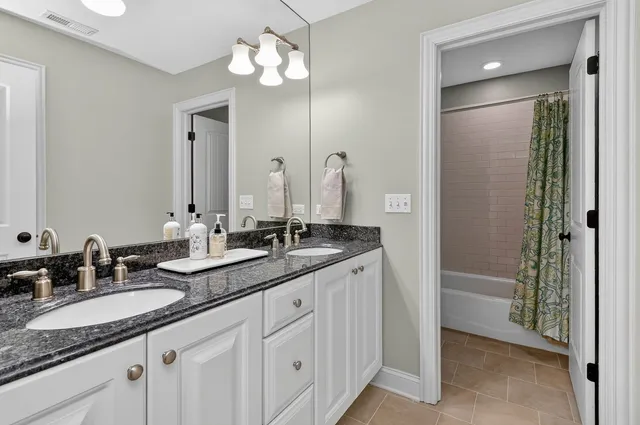 a bathroom with 2 sink and a mirror