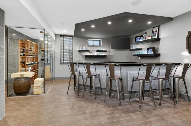 a kitchen with stainless steel appliances lots of white furniture a refrigerator and a stove