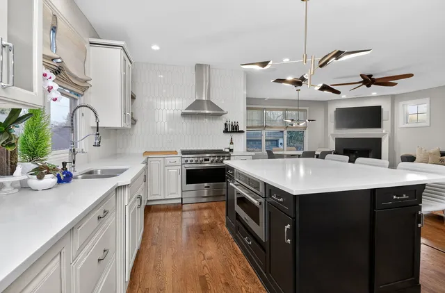 a kitchen with a sink a stove and chairs