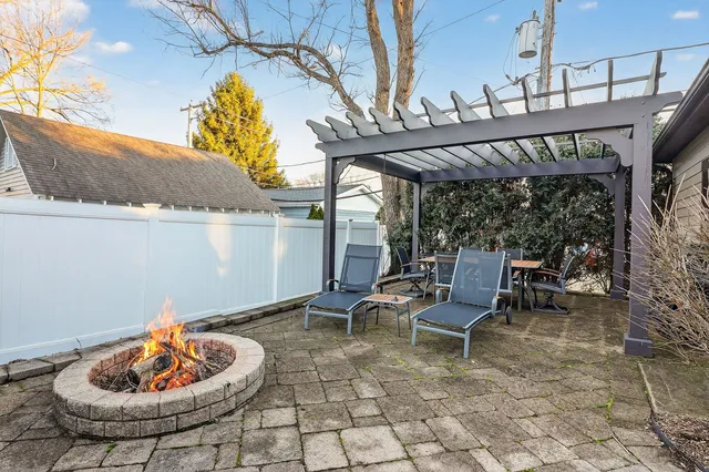 a backyard of a house with a table and chairs