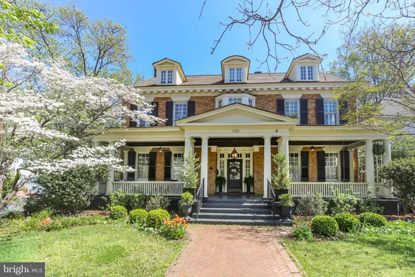 a view of a dining room with furniture a chandelier and wooden floor
