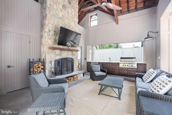 a living room with furniture fireplace and flat screen tv