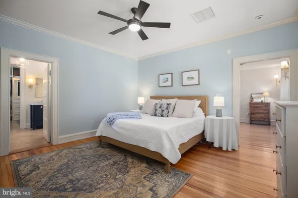 a bathroom with a granite countertop sink toilet and a mirror