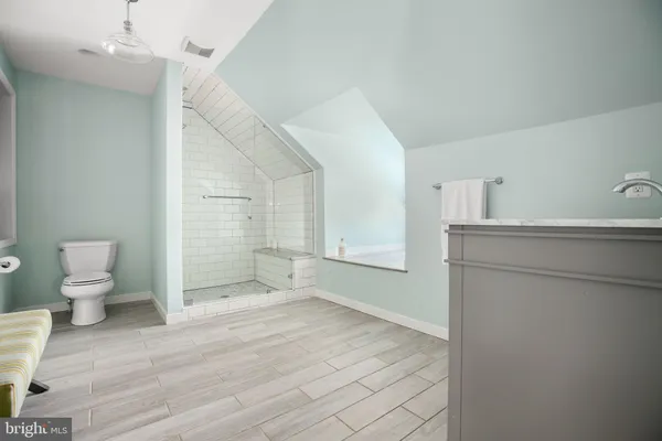 a bathroom with a sink mirror bathtub and toilet