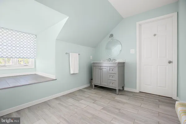 a front view of a house with yard and tree