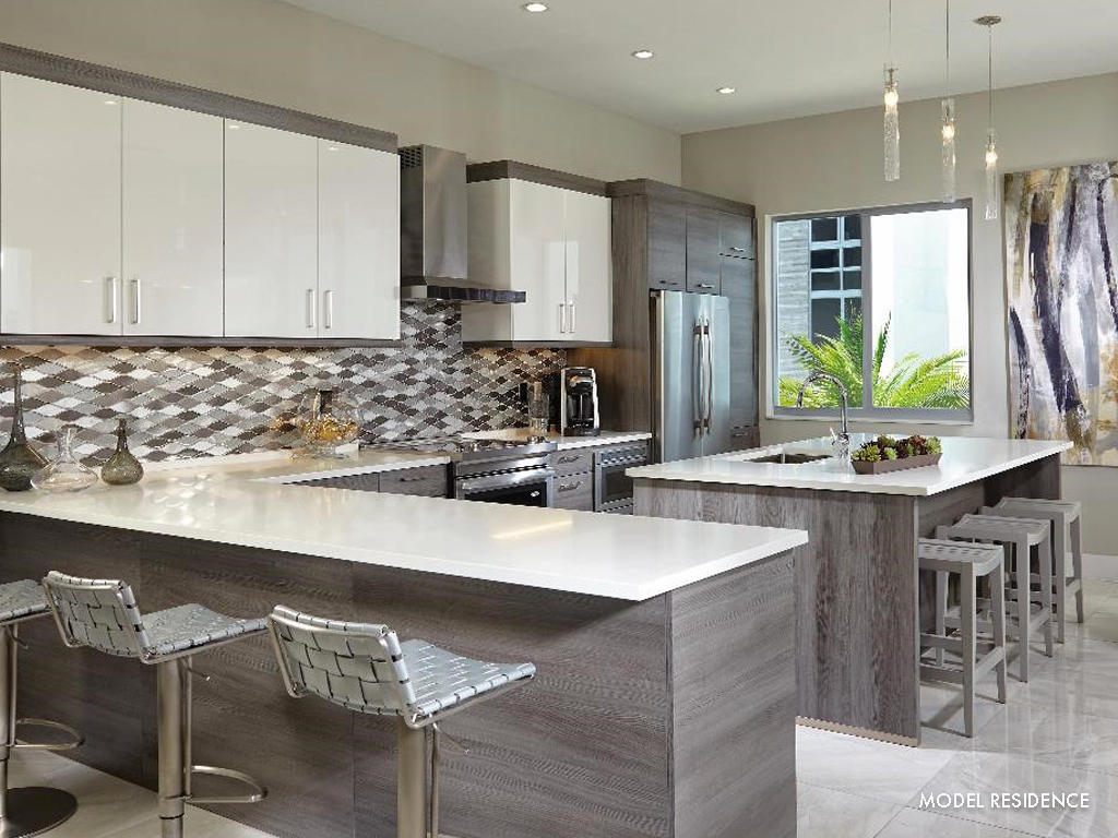 4010 Northwest 18th Way Boca Raton, FL 33431 - Photo 11 of 13 a kitchen with kitchen island granite countertop a table chairs sink and cabinets