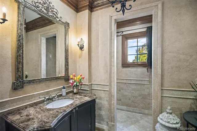a bathroom with a granite countertop sink and a mirror
