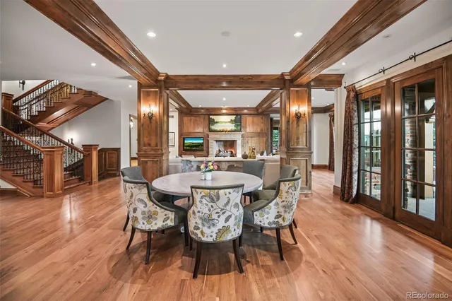 a dining room with furniture window and wooden floor