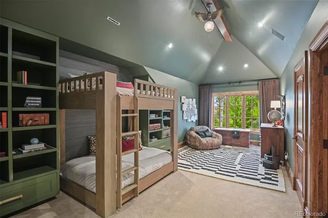 a bedroom with furniture and a large window