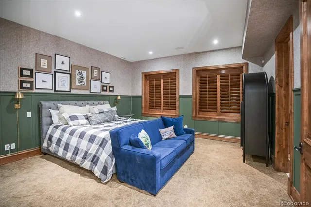 a bedroom with a bed couch and a window