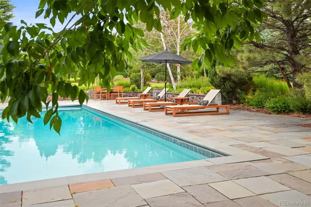 swimming pool view with a seating space