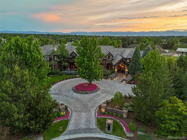 a view of a balcony with table and chairs and potted plants