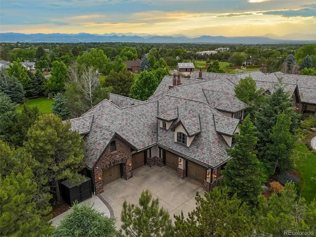 an aerial view of a house with a yard and lake view