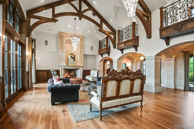 a living room with furniture a fireplace and a chandelier