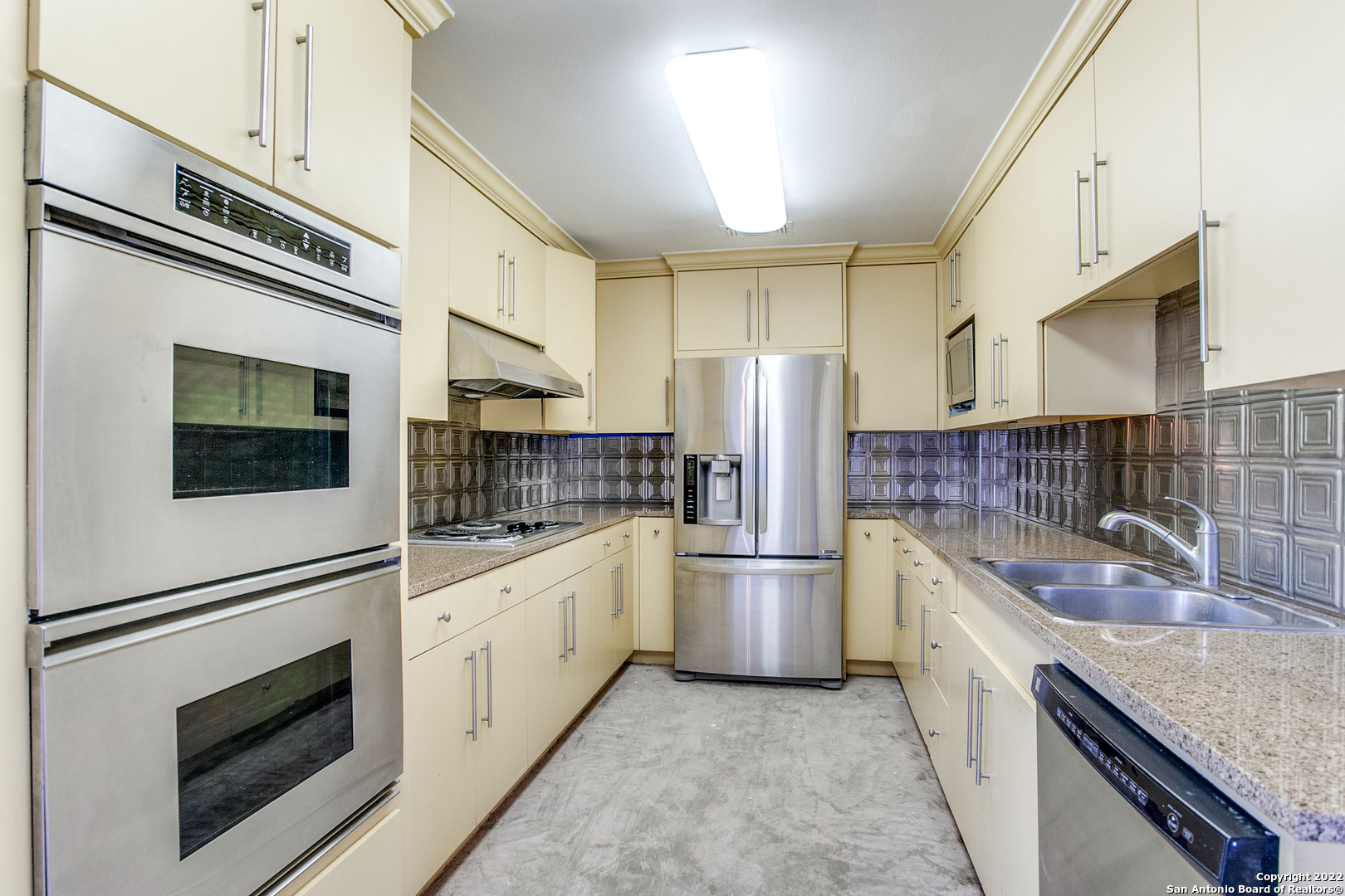 a kitchen with refrigerator cabinets and microwave