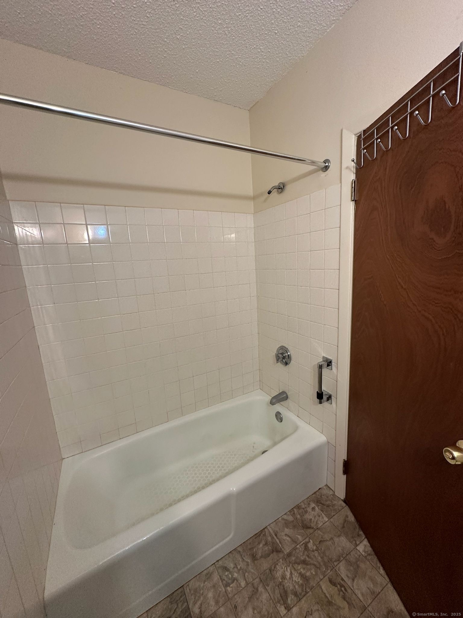 1660 East Main Street, Unit 5T Waterbury, CT 06705 - Photo 4 of 5 a bathroom with a shower and a bath tub