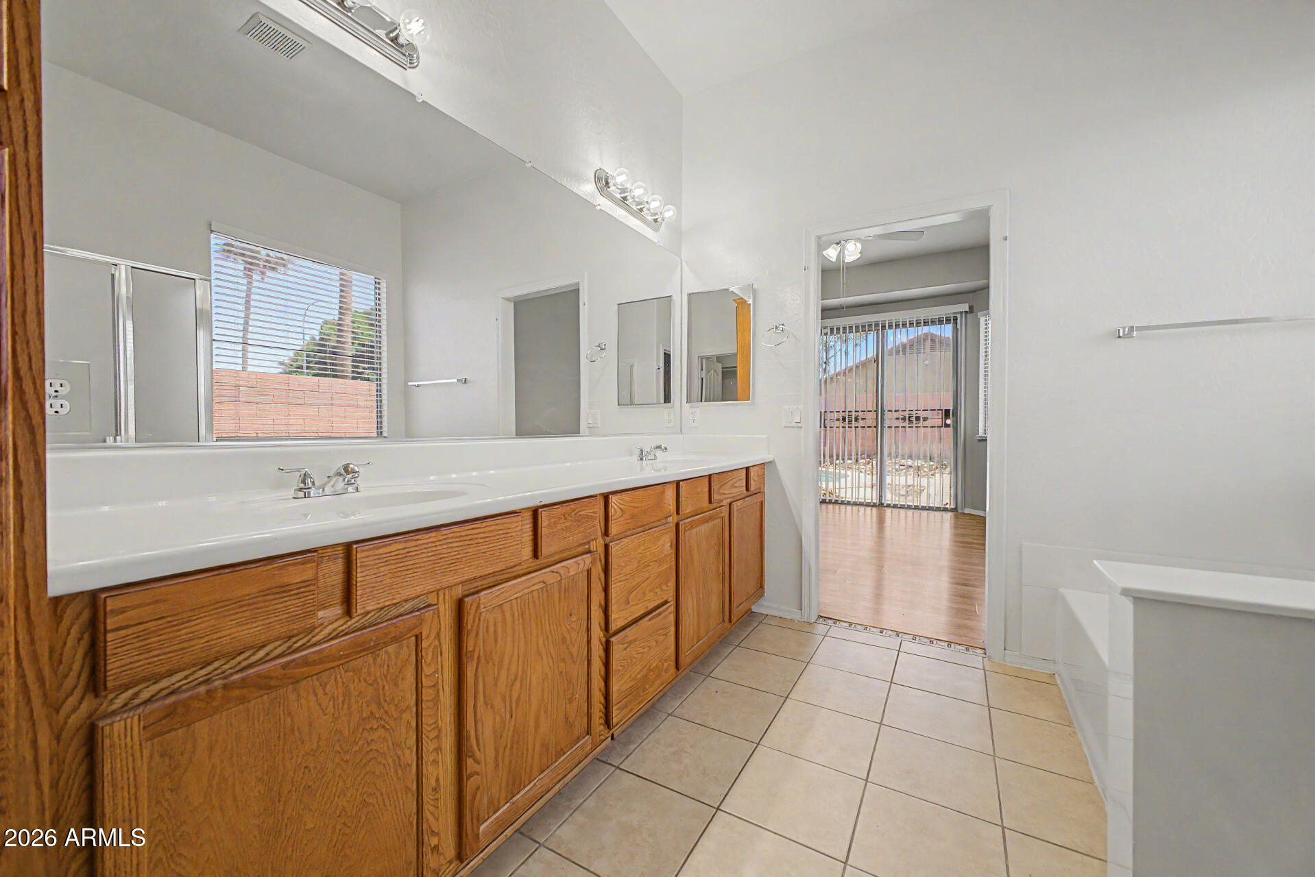 11199 West Monte Vista Road Avondale, AZ 85392 - Photo 18 of 36 a spacious bathroom with a sink a mirror and a bathtub